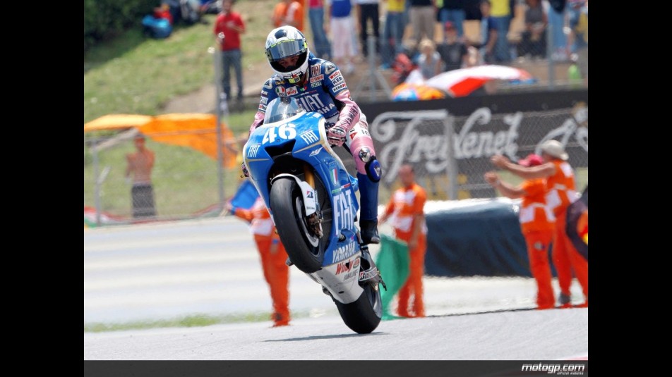 Valentino Rossi pulls off a wheelie after the race in Catalunya