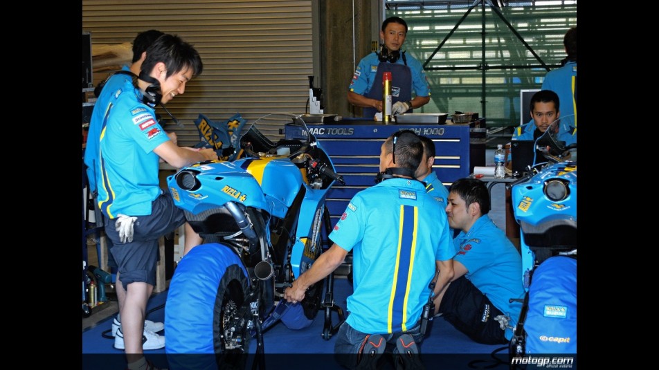 The Rizla Suzuki MotoGP team works on the bikes of Ben Spies and Nobuatsu Aoki