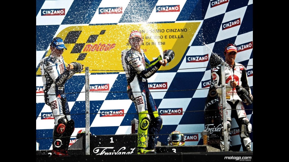 Lorenzo, Rossi and Elias celebrating victory on the podium at Misano