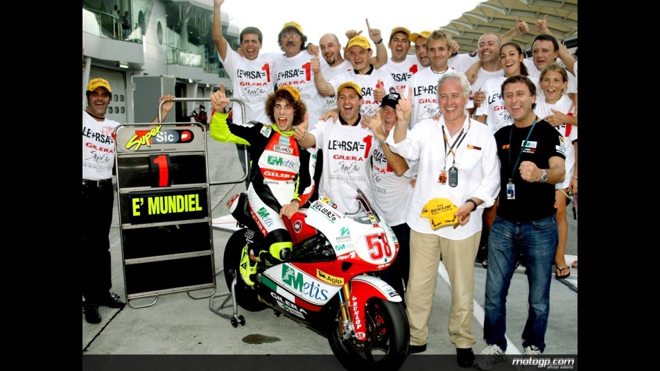 Simoncelli celebrates his 250cc World title with the Metis Gilera team