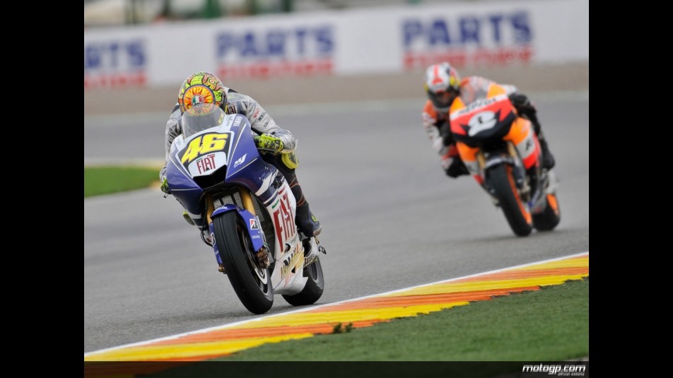 Valentino Rossi riding ahead of Dani Pedrosa action during Practice in Valencia