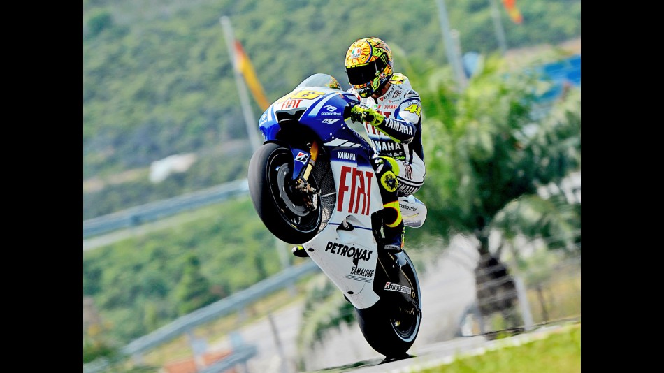 Valentino Rossi pulls off a wheelie in Sepang
