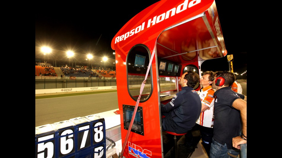 Alberto Puig, Raul Jara and Mike Leitner in the Repsol Honda pit wall during the race in Qatar