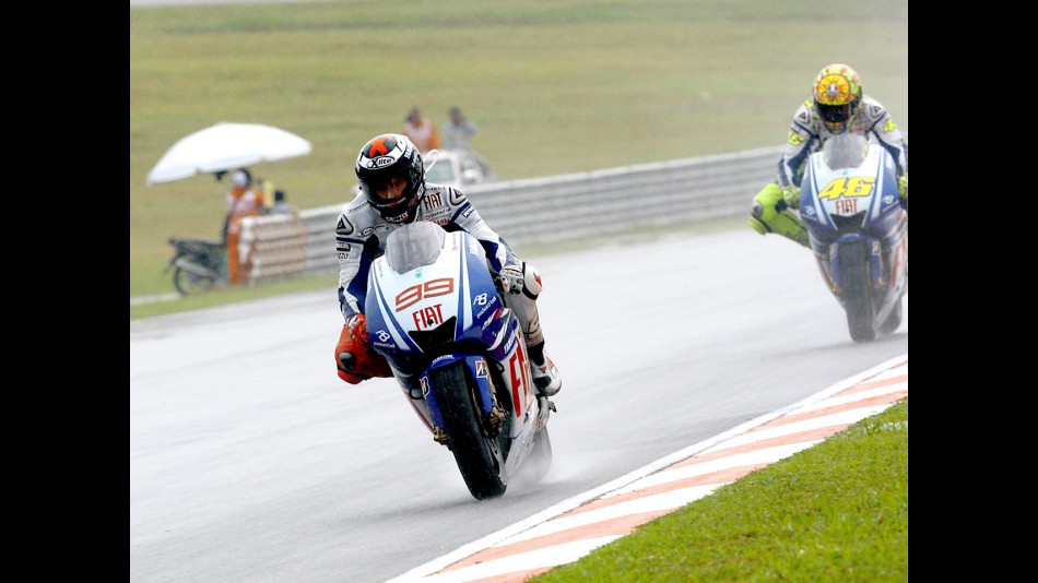 Lorenzo riding ahead of Rossi in Sepang