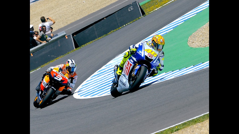 Valentino Rossi riding ahead of Dani Pedrosa during MotoGP race in Jerez