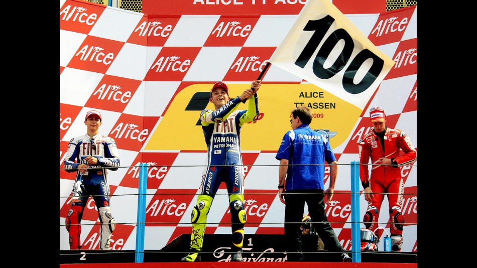 Valentino Rossi celebrates his 100th win on the podium in Assen
