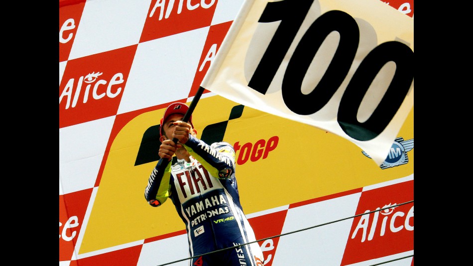 Valentino Rossi celebrates his 100th win on the podium in Assen