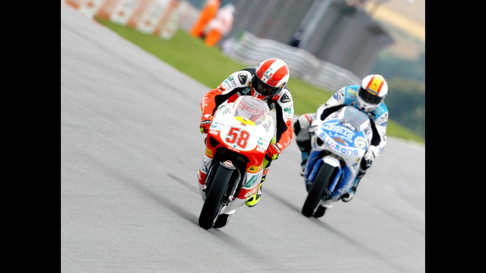 Marco Simoncelli riding ahead of Alex Debon in Sachsenring