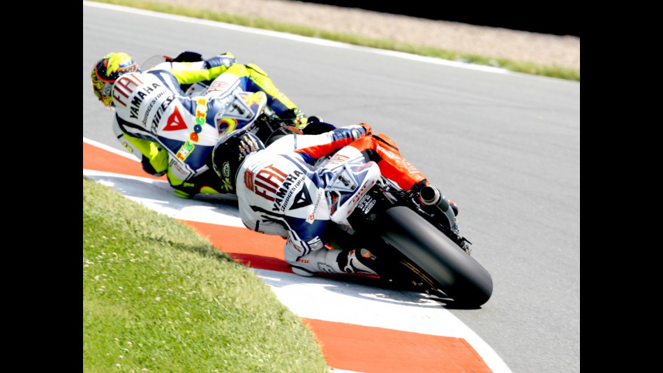 Valentino Rossi riding ahead of Jorge Lorenzo in Sachsenring