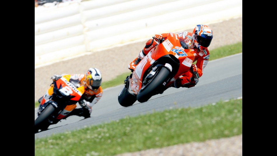 Casey Stoner riding ahead of Dani Pedrosa in Sachsenring