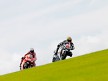 Gabor Talmacsi riding ahead of Nicky Hayden in Donington