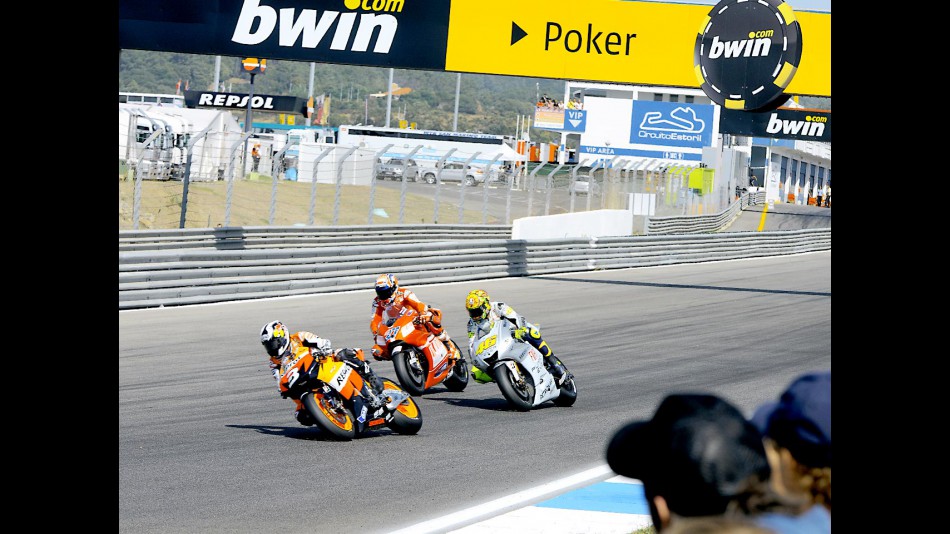 Pedrosa riding ahead of Stoner and Rossi at Estoril
