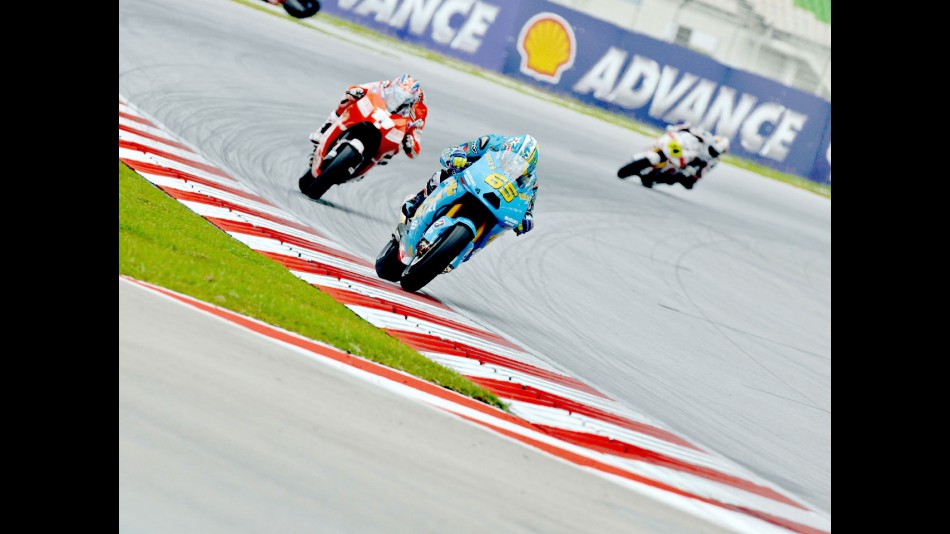 Capirossi riding ahead of Hayden in Sepang