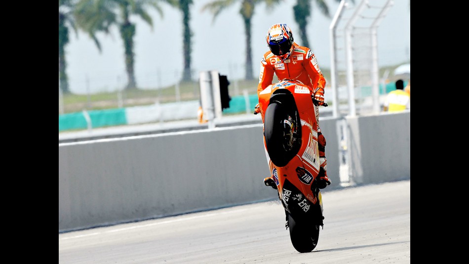 Casey Stoner pulls off a wheelie in Sepang