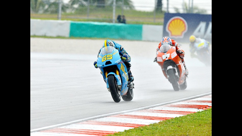 Loris Capirossi riding ahead of Hayden in Sepang