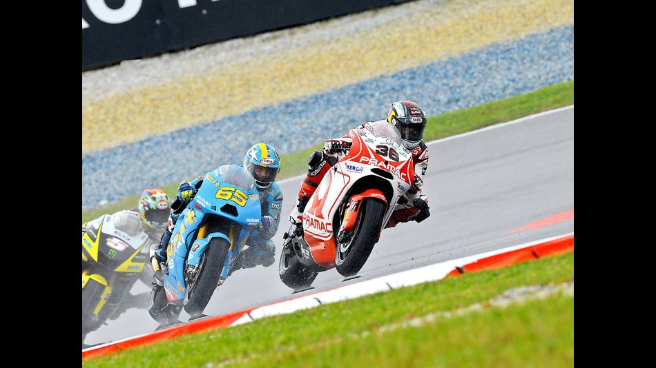 Kallio riding ahead of Capirossi and Edwards in Sepang