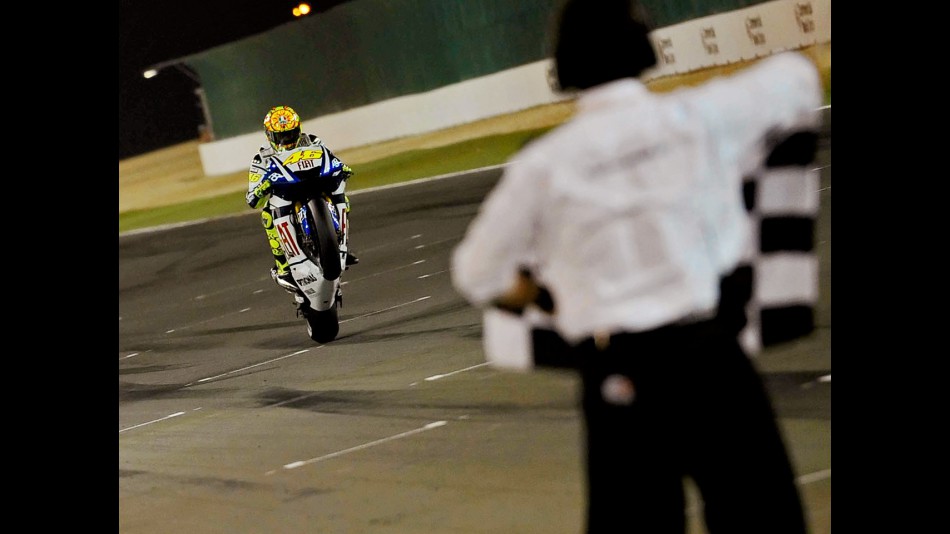 Valentino Rossi pulls off a wheelie at the finish of the race in Qatar