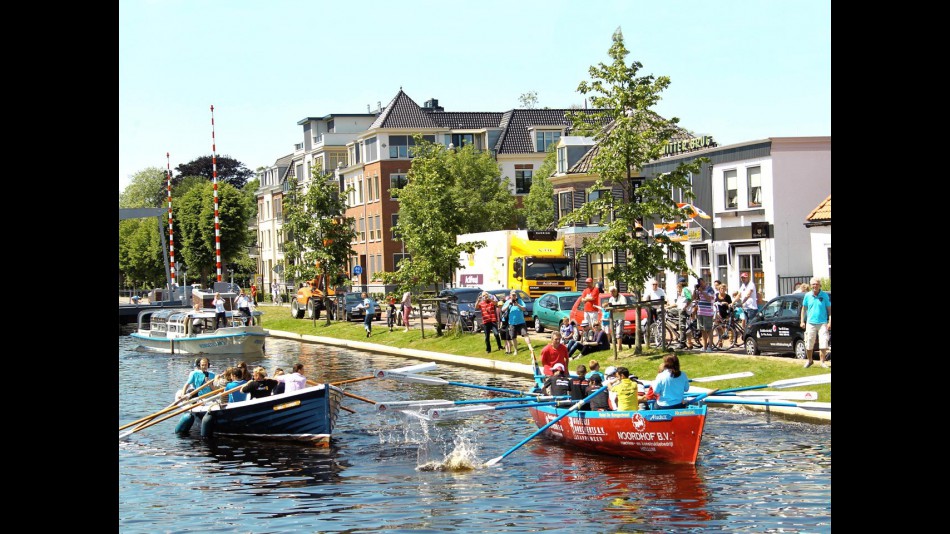 MotoGP riders and TV journalists take part in a boat race along the Assen canals