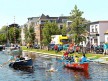 MotoGP riders and TV journalists take part in a boat race along the Assen canals