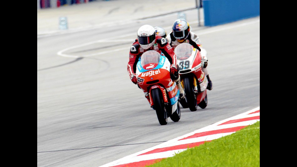 Danny Webb riding ahead of Luis Salom at Sepang